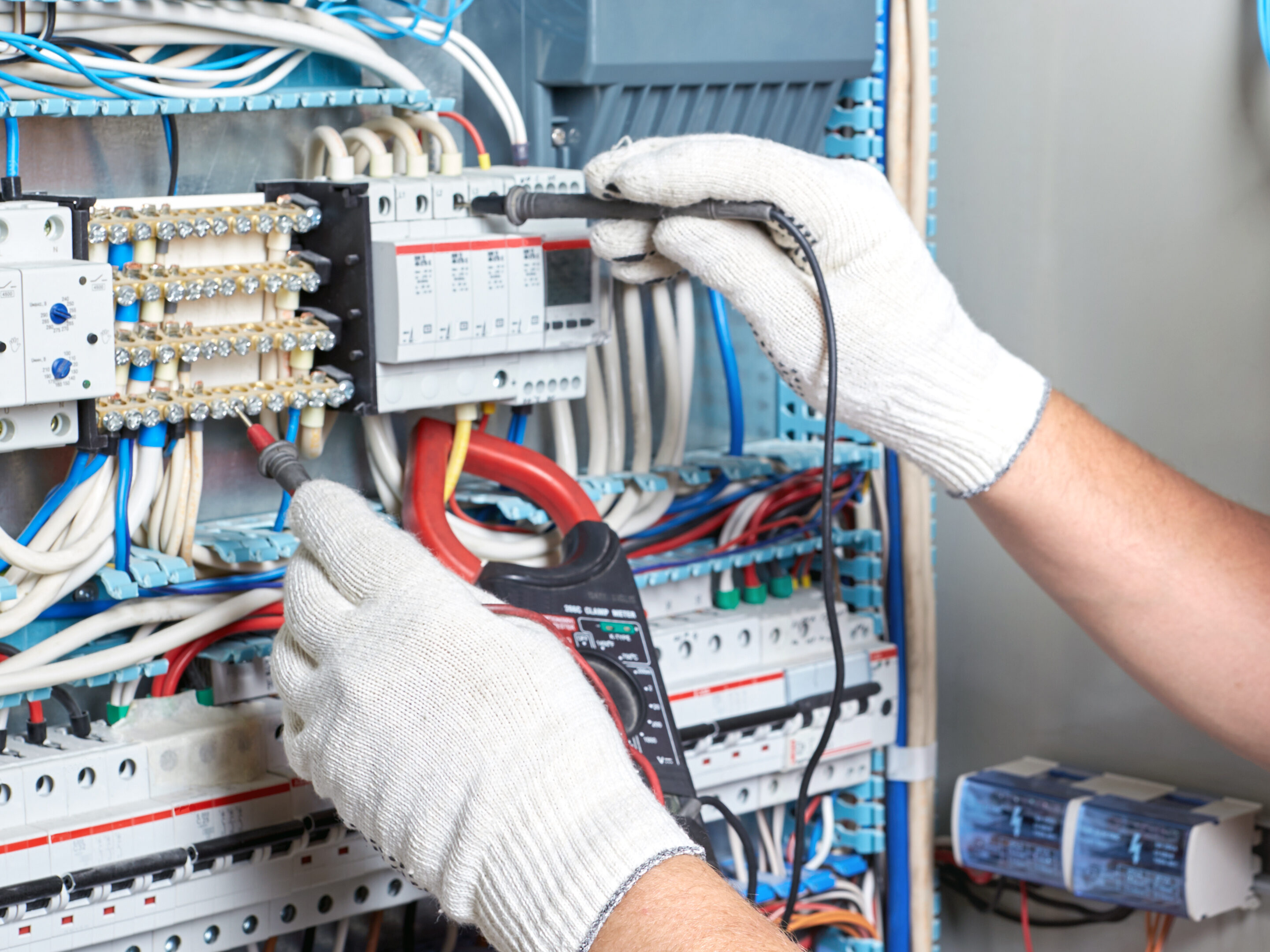 Closeup of an electrician's hand with a diagnostic tool in his hand